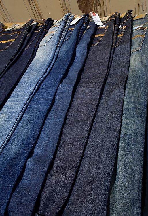 Selection of jeans at 14 oz. Store, Berlin, highlighted by ERCO Logotec spotlights.