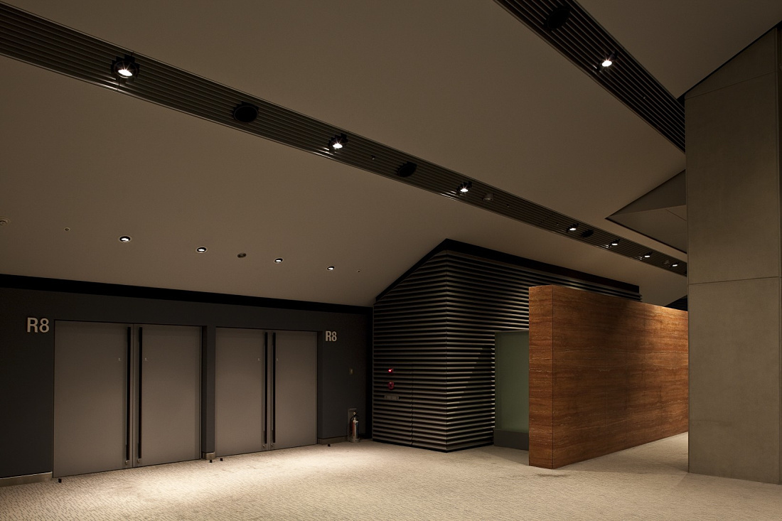 Tokyo International Forum interior featuring ERCO ceiling spotlights for energy-efficient lighting.