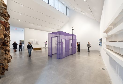Art exhibit featuring sculptures and wallwashers for even illumination.
