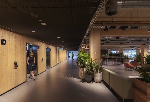 Wallwashers illuminate a hallway, creating a bright and inviting atmosphere.