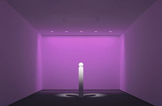 Accent lighting highlights an object on a pedestal in a room with colored light.
