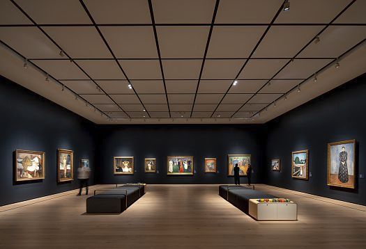 Accent lighting in an art gallery, highlighting paintings with track spotlights.