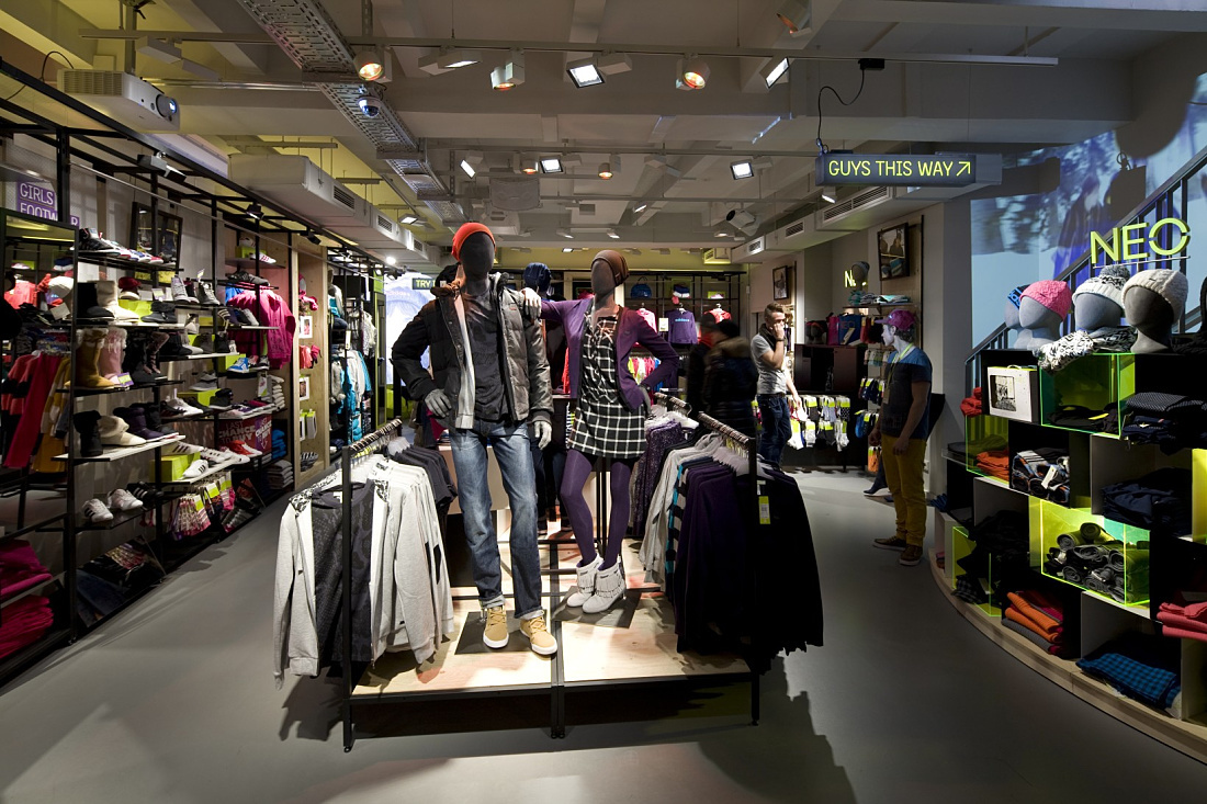 Adidas NEO store in Cologne featuring LED lighting and displayed apparel.