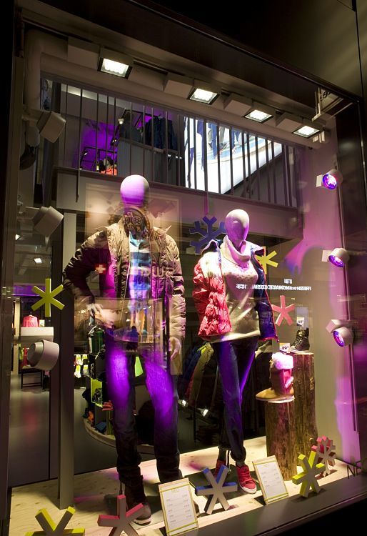 Adidas NEO store in Cologne featuring LED lighting and mannequins in winter apparel.