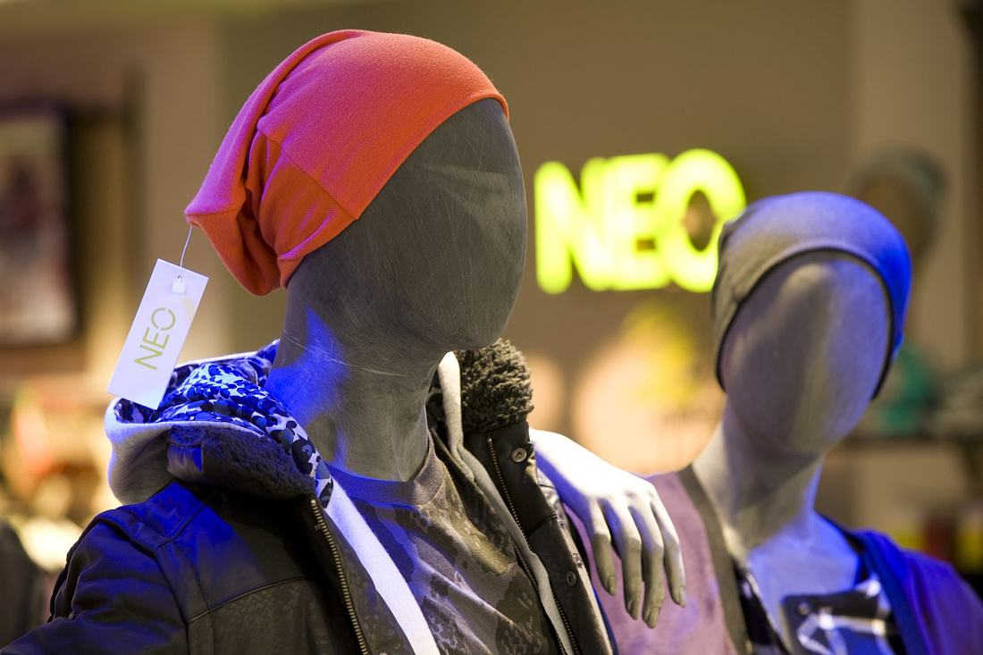 Adidas NEO store display: Mannequin with red beanie and jacket under LED lighting.