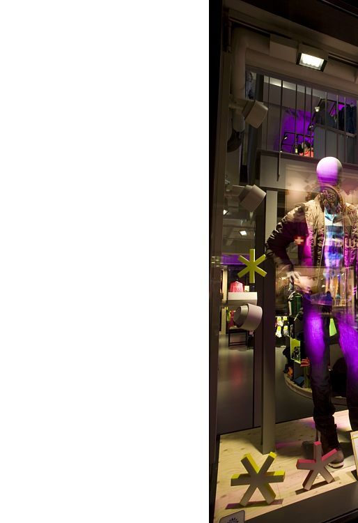 Adidas NEO store in Cologne featuring LED lighting and mannequins in winter apparel.