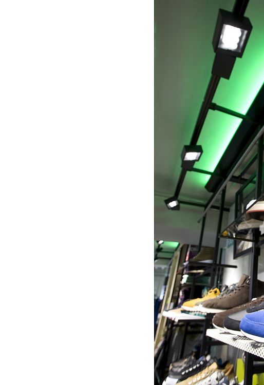 Adidas NEO shoes on display, illuminated by ERCO LED spotlights in Cologne store.