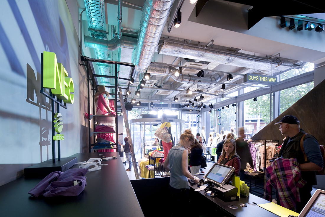 Adidas NEO store illuminated with ERCO Optec spotlights and varychrome LEDs for dynamic lighting.