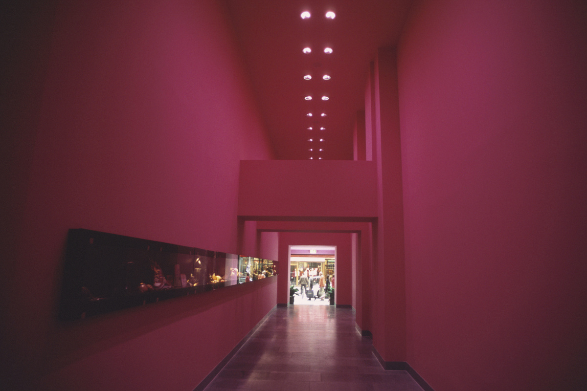 Interior with colored wall lighting and linear ERCO recessed ceiling lights.