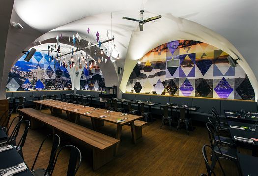 Interior of Ambiente Brasileiro restaurant in Prague, featuring ERCO LED lighting.