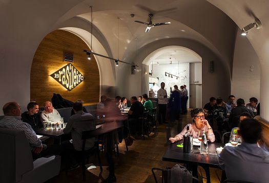 Interior of Ambiente Brasileiro restaurant in Prague, featuring ERCO LED lighting for ambiance.