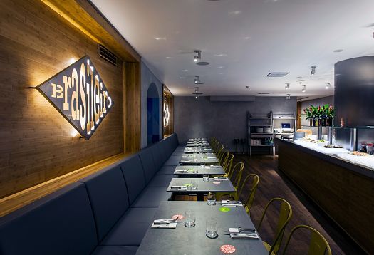 Interior of Ambiente Brasileiro restaurant in Prague, featuring ERCO LED lighting.