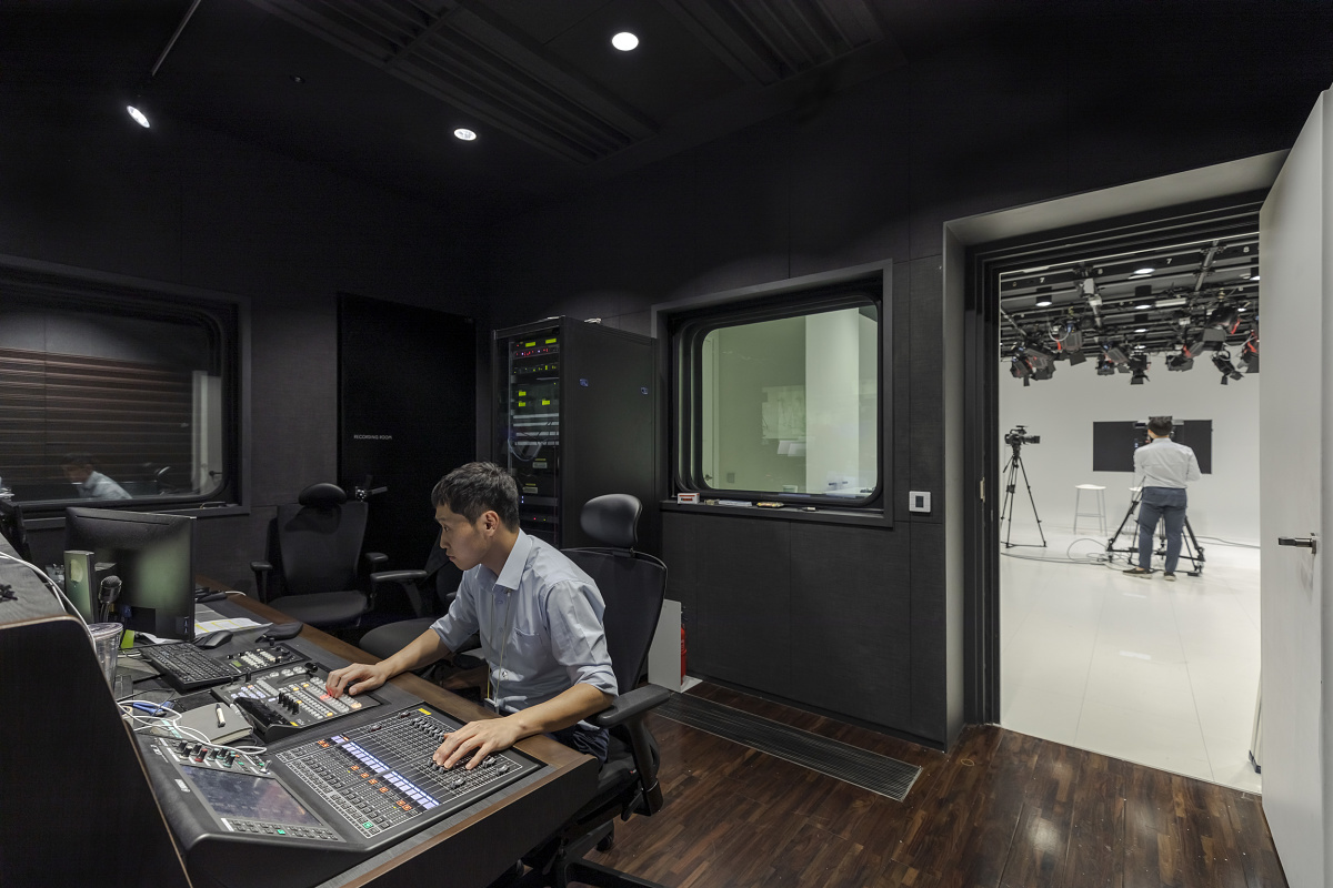 Audio engineer at mixing console in Amorepacific HQ, Seoul.