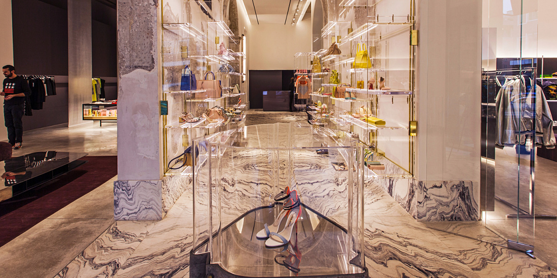 Interior of Antonia store in Milan, featuring Optec LED spotlights and Quintessence downlights highlighting luxurious materials.