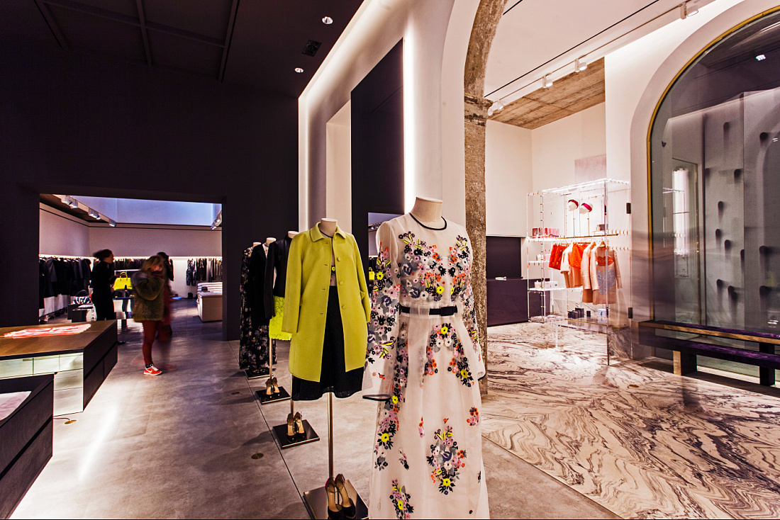 Interior of Antonia store in Milan, featuring fashion illuminated by ERCO Optec spotlights.
