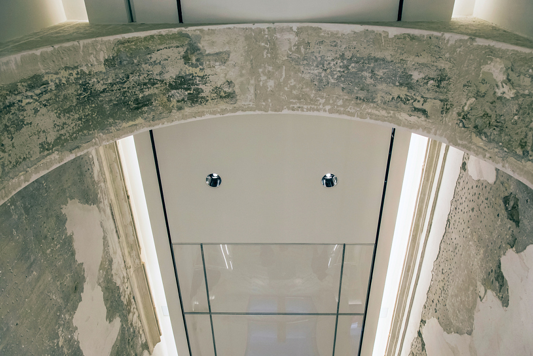 View through an archway to Optec LED spotlights in the Antonia Store, Milan.