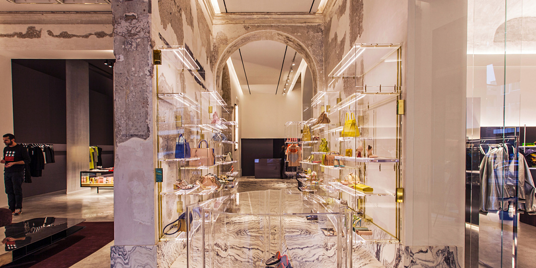 Interior of Antonia store in Milan, featuring Optec LED spotlights and Quintessence downlights highlighting luxurious materials.