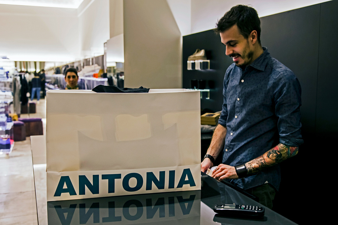 Cashier at Antonia store in Milan, featuring ERCO Optec spotlights for accent lighting.