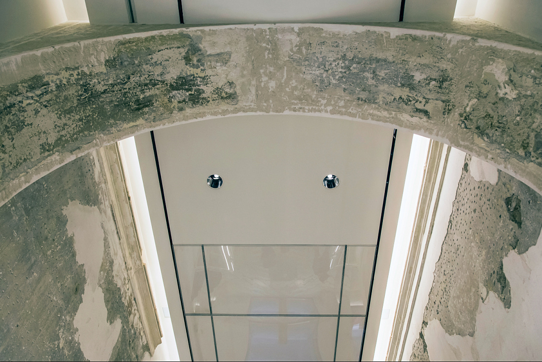 View through an archway to Optec LED spotlights in the Antonia Store, Milan.