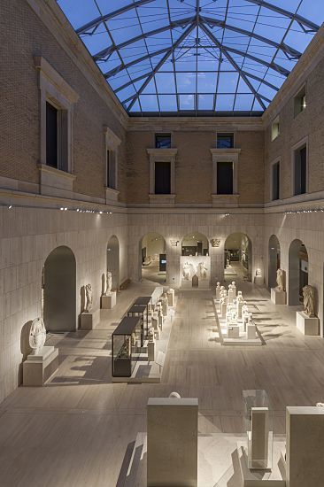 Interior of Madrid's Archaeological Museum featuring ERCO LED lighting highlighting historical exhibits.