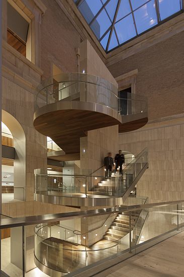Archaeological Museum, Madrid: Visitors on stairs with ERCO lighting accents.
