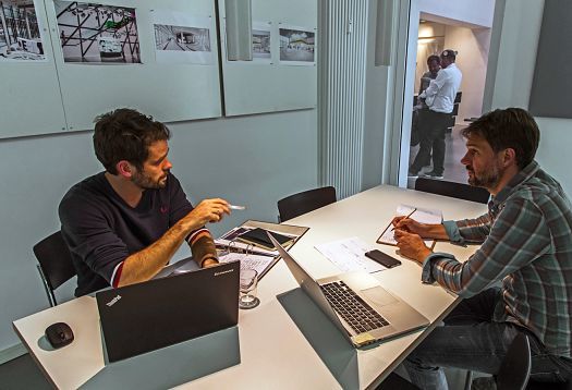 Archimedes agency offices, Berlin: Two people discussing lighting design with ERCO light.
