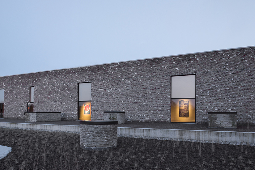 Axel Vervoordt Gallery featuring art illuminated by ERCO LED lighting in a historic industrial space.