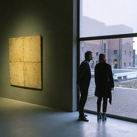 Visitors view art in the Axel Vervoordt Gallery, illuminated by ERCO LED spotlights.