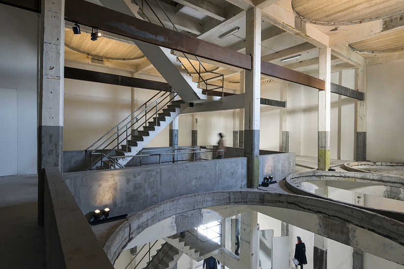 Axel Vervoordt Gallery interior featuring ERCO Parscan spotlights illuminating art in a converted distillery.