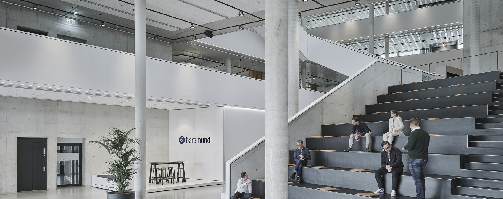 Baramundi Software AG headquarters featuring ERCO track lighting: flexible workspaces and high spaces with neutral white light.