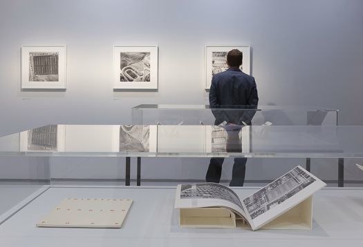 Visitor views art at the Barbican Gallery, illuminated by ERCO LED lighting.