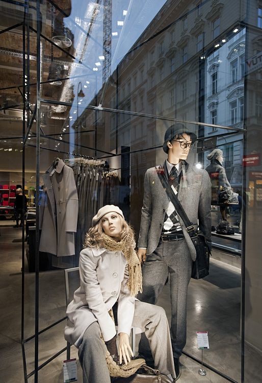 Benetton store window display featuring mannequins lit by ERCO LED lighting.
