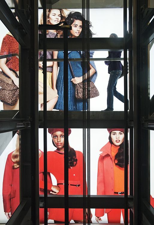 Benetton megastore in Vienna, featuring fashion illuminated by ERCO LED lighting, viewed through a steel structure.