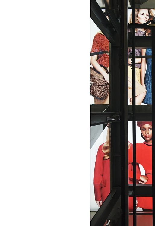 Benetton megastore in Vienna, featuring fashion illuminated by ERCO LED lighting, viewed through a steel structure.