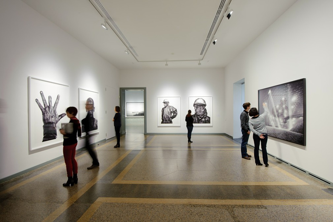 Visitors view the Industrious exhibition at the Berne Art Museum, illuminated by ERCO Light Board LED spotlights.