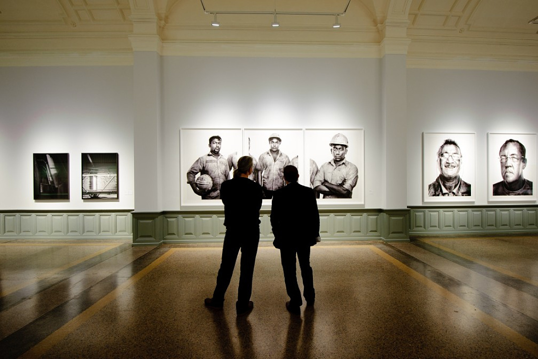 Visitors view the Industrious exhibit at the Berne Art Museum, illuminated by Light Board LED spotlights.
