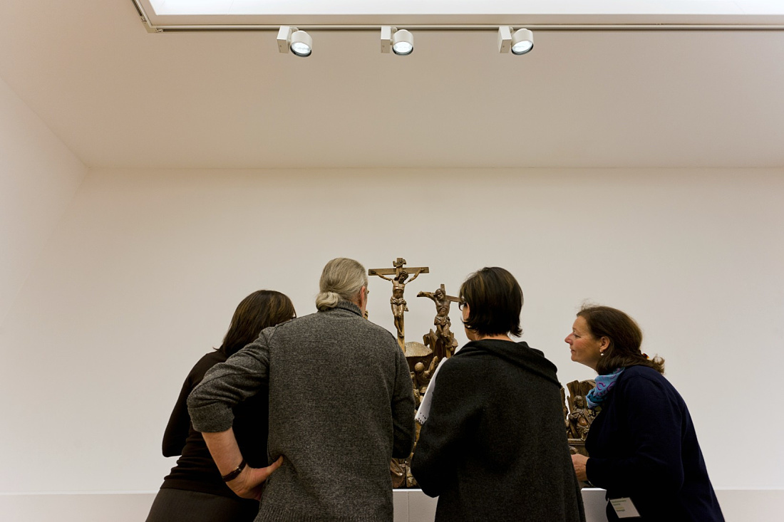 Visitors view religious art at the Bonnefanten Museum, illuminated by ERCO Optec LED spotlights.