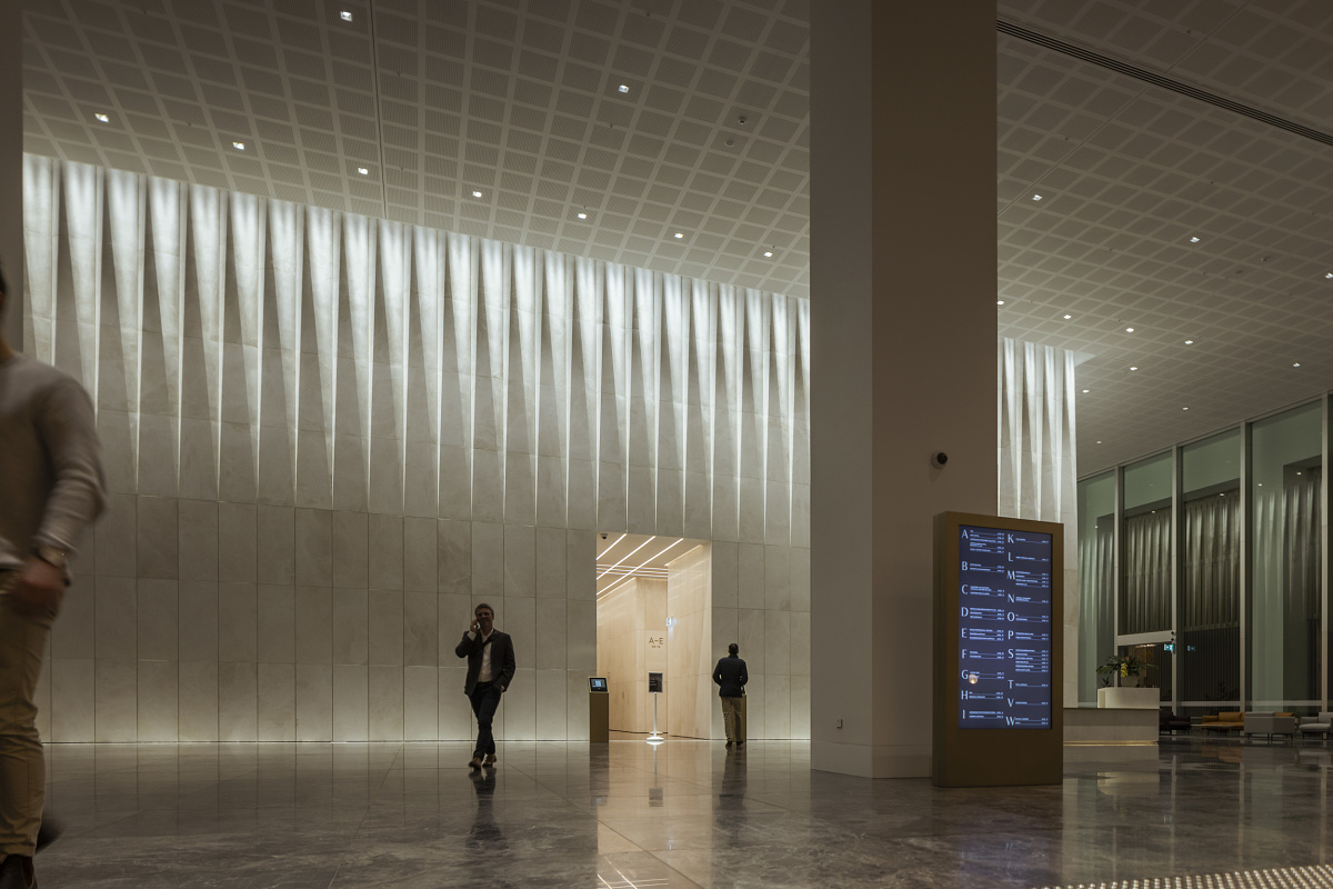 ERCO Gimbal recessed spotlights in Melbournes Bourke Place Lobby, creating wallwashing with high ceilings.