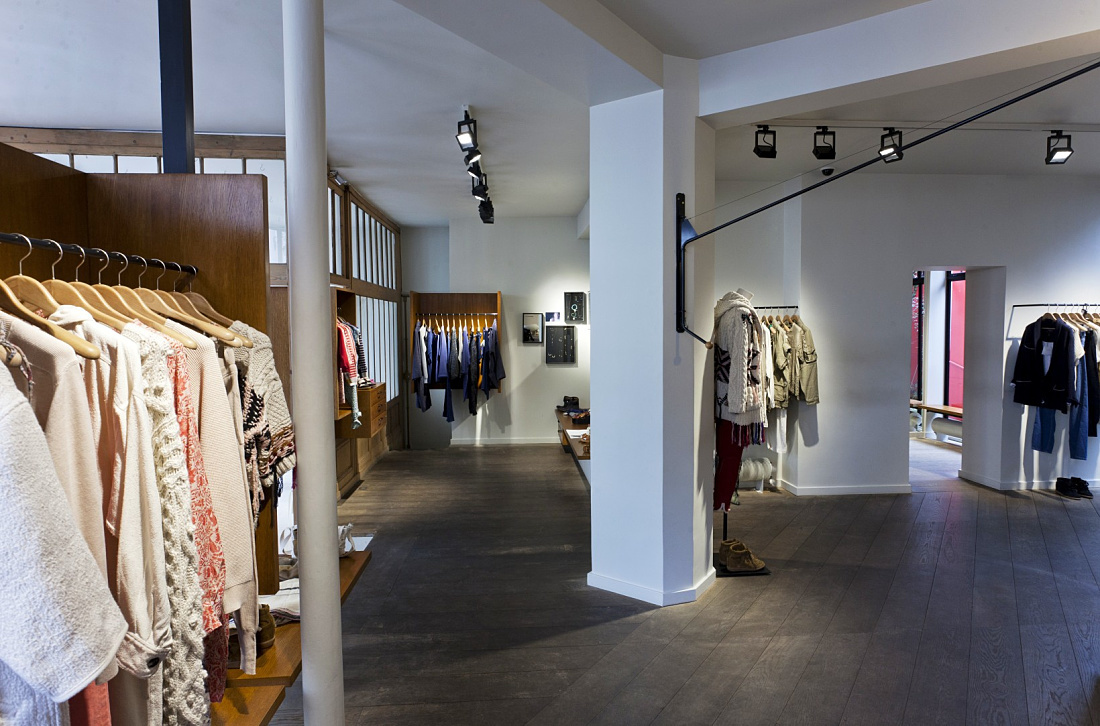 Modern LED lighting in a Paris fashion boutique, dynamically displaying clothing.