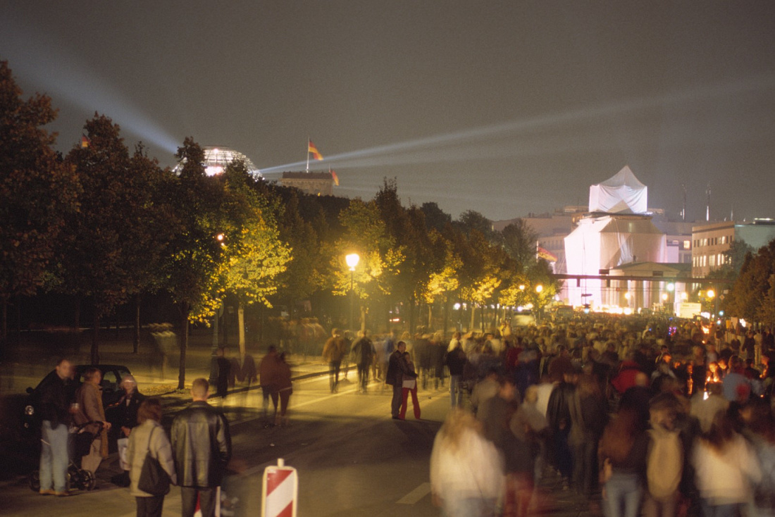Illuminated Brandenburg Gate in Berlin at night, a symbol of German unity.