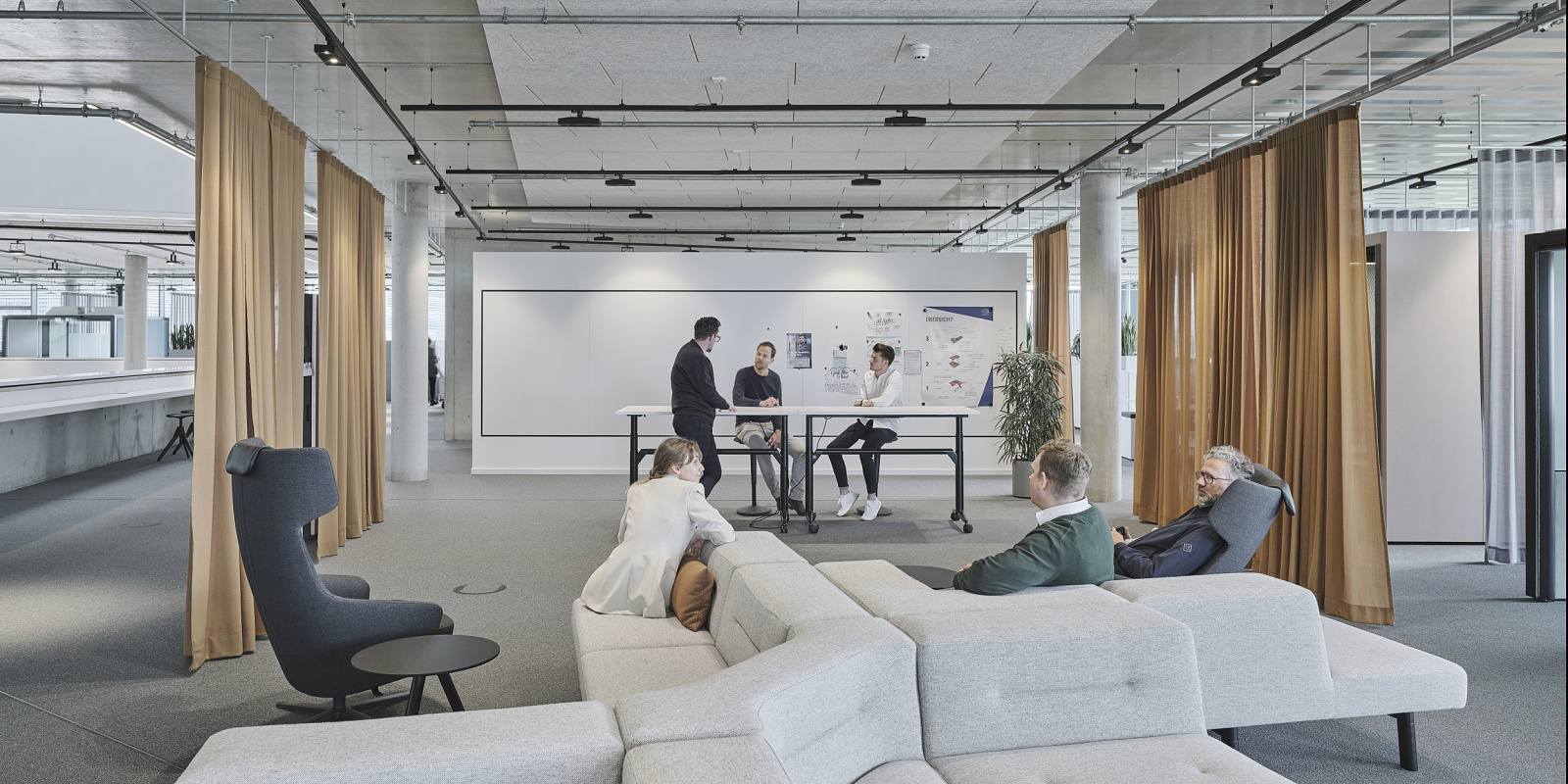 Modern office lighting concept with ERCO light, designed for collaborative work and well-being.