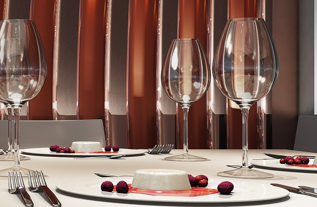 Elegant table setting with dessert and glassware, highlighting brilliance through light reflection.
