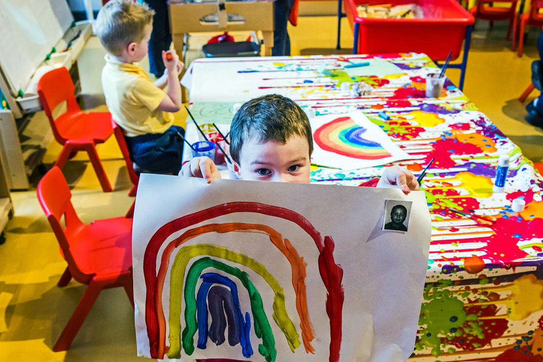 Child displaying rainbow art at Brontë Nursery, Rathfriland.