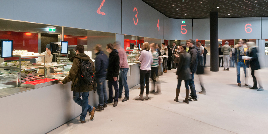 Cafeteria at Vienna University with ERCO lighting, designed for social interaction.