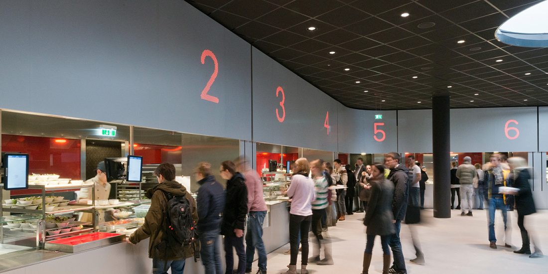 Cafeteria at Vienna University with ERCO lighting, designed for social interaction.