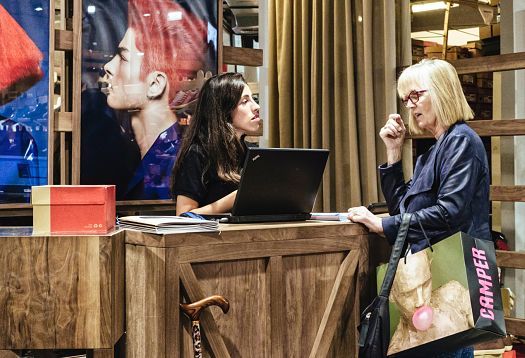 Customer at the Camper store in Barcelona checking out at the till.
