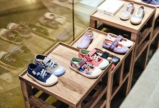 Camper shoes displayed on shelves, illuminated by ERCO LED lighting in the Camper store, Barcelona.