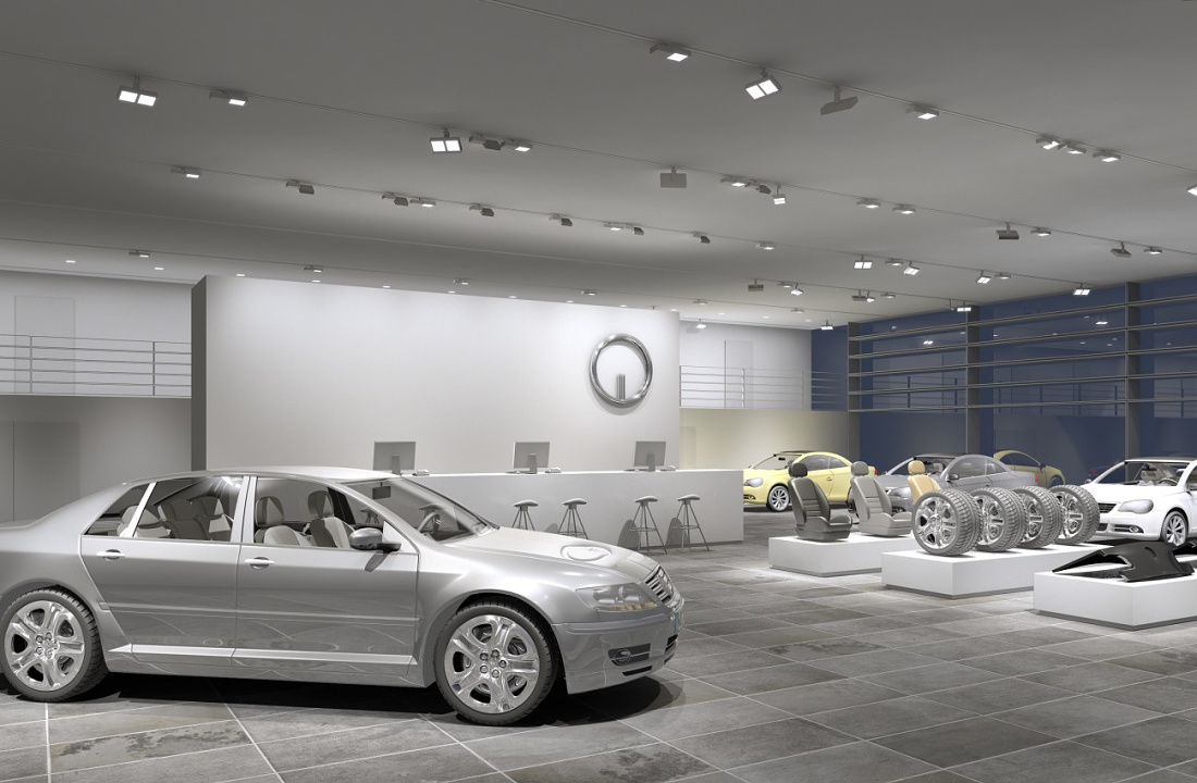 Car dealership showroom featuring ERCO lighting, accentuating vehicles and enhancing the brand image.