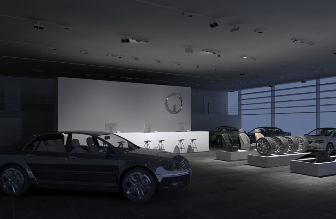 Car dealership interior featuring ERCO lighting, highlighting vehicles and accessories to enhance brand image.