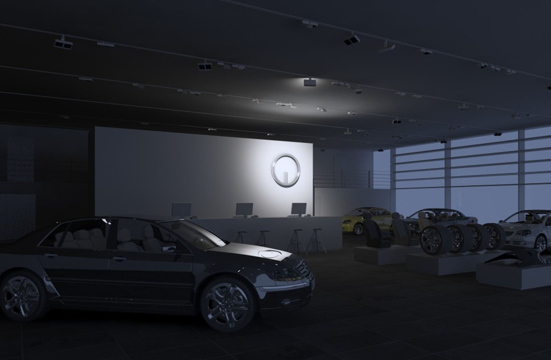 Car dealership lighting using ERCO spotlights to highlight vehicles and enhance the showroom ambiance.